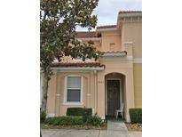 Charming home featuring a welcoming entrance, light-colored stucco, and attractive landscaping at 2662 Mayaguana St, Kissimmee, FL 34747