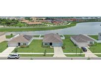 An aerial view showcasing the home's location near a pond and walking trails at 392 Citrine Loop, Kissimmee, FL 34758