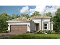 Beautiful single-story home featuring a two-car garage, well-manicured lawn, and classic architectural details at 4215 Barbuda Ln, Kissimmee, FL 34758