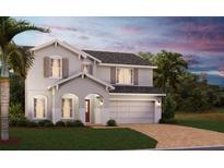 Charming two-story home with a brick driveway, two-car garage, and nicely landscaped front yard at 6014 Vision Rd, St Cloud, FL 34771