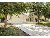 Charming single-Gathering home with a two-car garage and a well-maintained front yard at 672 Reindeer Dr, Kissimmee, FL 34759