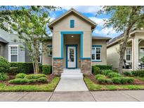 Charming single-story home featuring a well-manicured lawn and inviting blue-accented entryway at 8245 Laureate Blvd, Orlando, FL 32827