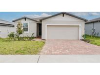 Charming single-Gathering home featuring a brick driveway and well-maintained front yard at 856 Teton St, Haines City, FL 33844