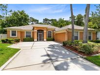 Charming single-story home featuring a well-manicured lawn and a spacious driveway at 9330 Shadow Pinar Ct, Orlando, FL 32825
