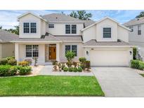 Charming two-story home featuring a well-manicured lawn and inviting front entrance at 10125 Sandy Marsh Ln, Orlando, FL 32832