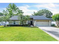 Charming single-story home featuring a lush green lawn, well-maintained landscaping, and an attached two-car garage at 227 Morning Glory Dr, Lake Mary, FL 32746