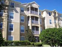 Attractive exterior view of condominium with balconies and manicured landscaping at 2778 Almaton Loop # 302, Kissimmee, FL 34747