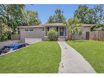 Charming home with a well-manicured lawn, gray brick, and inviting walkway at 300 Hickory Ct, Apopka, FL 32712