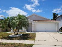 Charming one-story home with a well-manicured lawn and attached two-car garage at 3156 Natoma Way, Orlando, FL 32825
