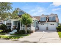 Charming two-story home featuring a three-car garage and inviting front porch at 4608 Atwood Dr, Orlando, FL 32828