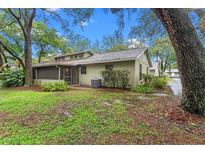 Charming single-story home with a screened porch and lush landscaping at 4772 Lake Ridge Rd # 66, Orlando, FL 32808