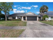 Charming single-story home with a well-maintained lawn, mature tree, and a two car garage at 622 Tomlinson Ter, Lake Mary, FL 32746