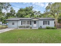 Charming single-story home featuring a well-maintained lawn and neutral color palette at 826 S Montgomery Ave, Deland, FL 32720