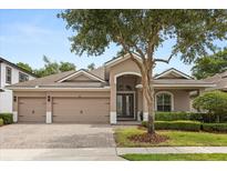 Beautiful single-story home with a three-car garage, well-manicured landscaping and a charming front entrance at 886 Sherbourne Cir, Lake Mary, FL 32746