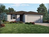 Charming single-story home with a lush green lawn and well-maintained landscaping at 1114 Cumberland Trail Dr, Lake Hamilton, FL 33851