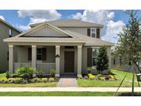 Charming two-story home with covered porch, manicured lawn, and beautiful landscaping at 11176 Hollow Bay Dr, Winter Garden, FL 34787