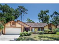 Charming single-story home with well-maintained landscaping and a two-car garage at 1241 Leatherwood Dr, Altamonte Springs, FL 32714