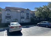 Exterior view of the building with clean curb appeal and ample parking spots at 14001 Fairway Island Dr # 525, Orlando, FL 32837