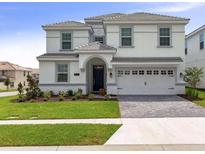 Charming two-story home with manicured lawn and a two-car garage at 1575 Plunker Dr, Davenport, FL 33896