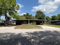 Inviting single-story home with a covered carport and well-kept lawn at 2506 Perrine Pl, Orlando, FL 32808