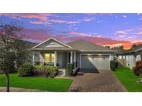 Charming single-story home features a well-maintained front yard and a two-car garage at 338 Wooded Vine Dr, Winter Springs, FL 32708