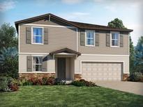 Charming two-story home featuring stone accents, neutral siding, and a two-car garage at 4977 Kaia Ave, Winter Haven, FL 33884