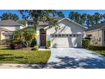 Charming two-story home with manicured lawn, mature landscaping, and attached two-car garage in a well-maintained neighborhood at 5007 Bellthorn Dr, Orlando, FL 32837