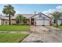 Charming single-Gathering home with well-manicured lawn, stone accents, and a two-car garage at 520 Starstone Dr, Lake Mary, FL 32746