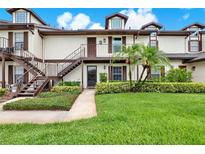 Inviting two-story condo with well-manicured lawn and lush tropical landscaping at 600 Northern Way # 103, Winter Springs, FL 32708