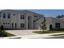 Stunning two-story home featuring a brick driveway, a symmetrical facade, and a two-car garage at 6125 Village Edge Pl, Sanford, FL 32771