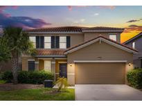 Charming two-story home with a well-maintained lawn and a two-car garage at 7041 Oakwood St, Davenport, FL 33837