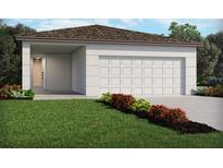 Charming one-story home with a two-car garage, well-manicured lawn, and colorful flower beds at 911 Donahue Pass, Lake Hamilton, FL 33851