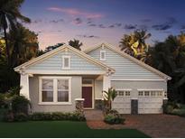 Charming single-story home featuring craftsman-style architecture and a two-car garage in a lush, tropical landscape at 11003 Hollow Bay Dr, Winter Garden, FL 34787