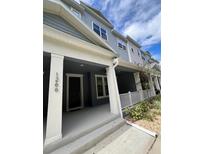 Charming townhome exterior with a welcoming front porch and well-maintained landscaping at 1266 Spotted Sandpiper Loop, Winter Springs, FL 32708