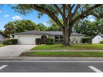 Charming one-story home with a lush front lawn and mature trees offering ample shade at 146 Tollgate Trl, Longwood, FL 32750