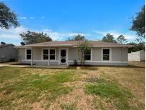 Charming single story home with well-maintained lawn, neutral color, and inviting front entrance at 3090 Yorkshire Dr, Deltona, FL 32738