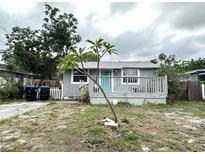 Charming single-story home with a cozy front porch, a pop of color with the blue door, and a simple, clean landscape at 332 S Observatory Dr, Orlando, FL 32835
