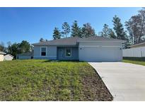Charming one-story home with a well-manicured lawn and a two-car garage at 5153 Sw 159Th St, Ocala, FL 34473