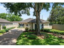 Charming single story home featuring mature trees, lush landscaping, and a private courtyard at 5973 Chesapeake Park # 58, Orlando, FL 32819