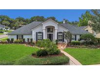 Charming single Gathering home featuring well-manicured lawn and attractive front yard landscaping at 605 Macglenross Dr, Oviedo, FL 32765