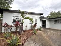 Charming single-story home featuring a well-maintained yard, mature landscaping and a concrete driveway at 6615 Beamer Way, Orlando, FL 32807