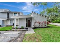 Charming townhome featuring a landscaped front yard and neutral gray exterior at 701 Saint Michael Ln, Altamonte Springs, FL 32714