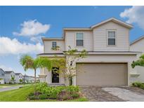 Charming two-story home featuring a two-car garage, well-manicured lawn, and inviting curb appeal at 1221 Aloha Blvd, Davenport, FL 33897