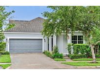 Charming single-Gathering home with gray exterior, attached garage, and landscaped front yard at 12691 Calderdale Ave, Windermere, FL 34786