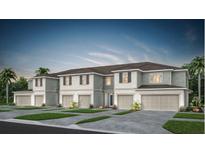 Charming townhome features a neutral color palette, attached garages, and lush landscaping at 3156 Emerald Acres Ln, Sanford, FL 32771