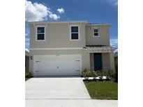 Charming two-story home featuring a two-car garage, neutral exterior, and well-manicured lawn at 3445 Briarwood Grove Dr, Ocoee, FL 34761