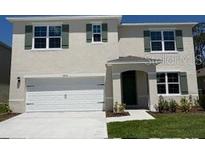 Charming two-story home featuring a two-car garage, well-maintained lawn, and decorative shutters on all windows at 3445 Briarwood Grove Dr, Ocoee, FL 34761