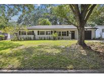 Charming single-story home boasts a tidy lawn and mature trees enhancing curb appeal at 3520 N Westmoreland Dr, Orlando, FL 32804