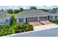 Charming villa with a two-car garage, neutral paint, and landscaped front yard at 5215 Nw 34Th St, Ocala, FL 34482