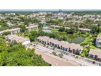 Beautiful aerial view of the community featuring lush landscaping, a tranquil pond, and a sparkling pool at 6 Escondido Cir # 55, Altamonte Springs, FL 32701